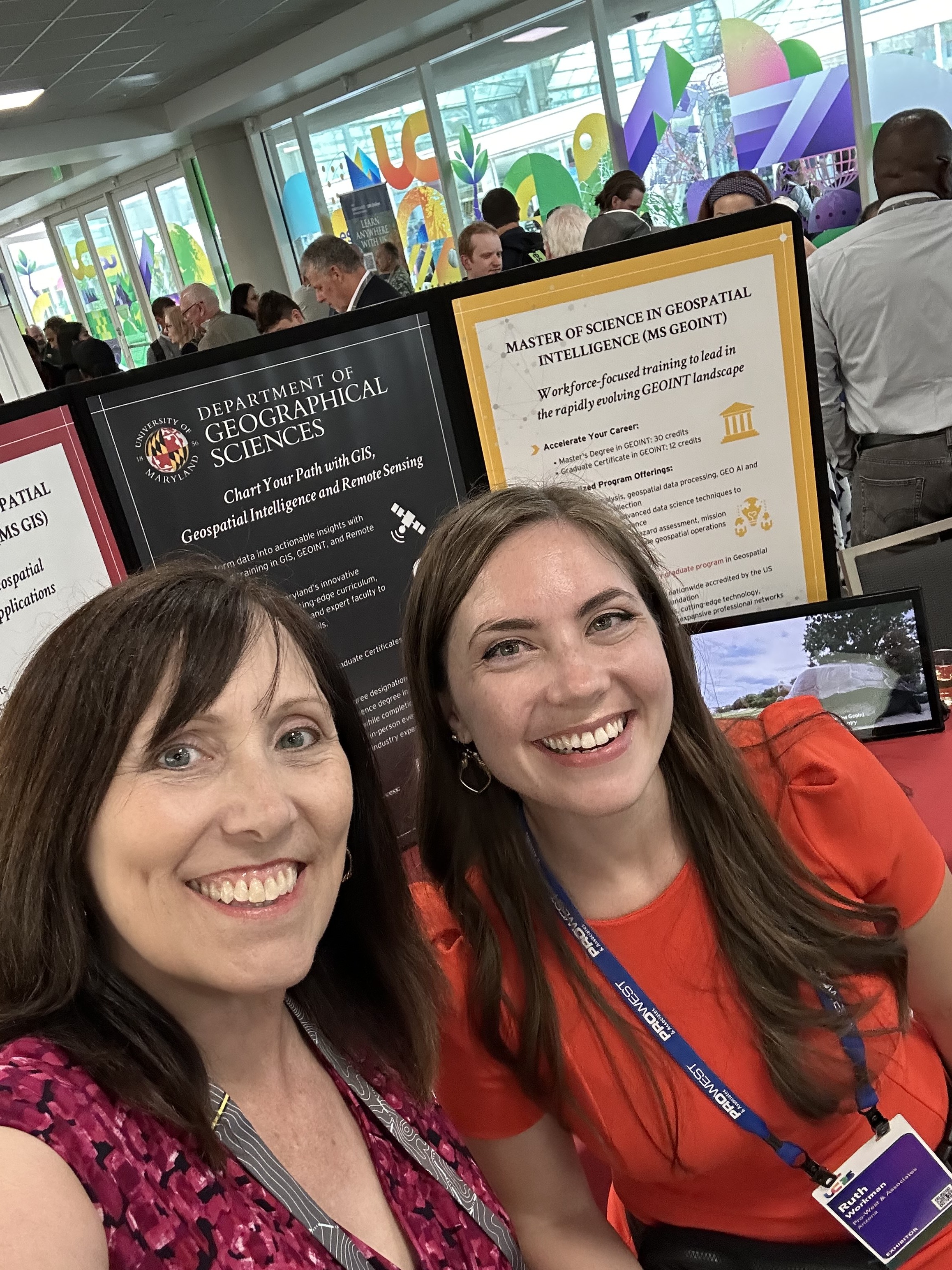 Image 4: Ruth Workman (Right) and program coordinator Erin Jacobs (Left) at the MS GIS and GEOINT table during the Academic Fair at the Esri User Conference