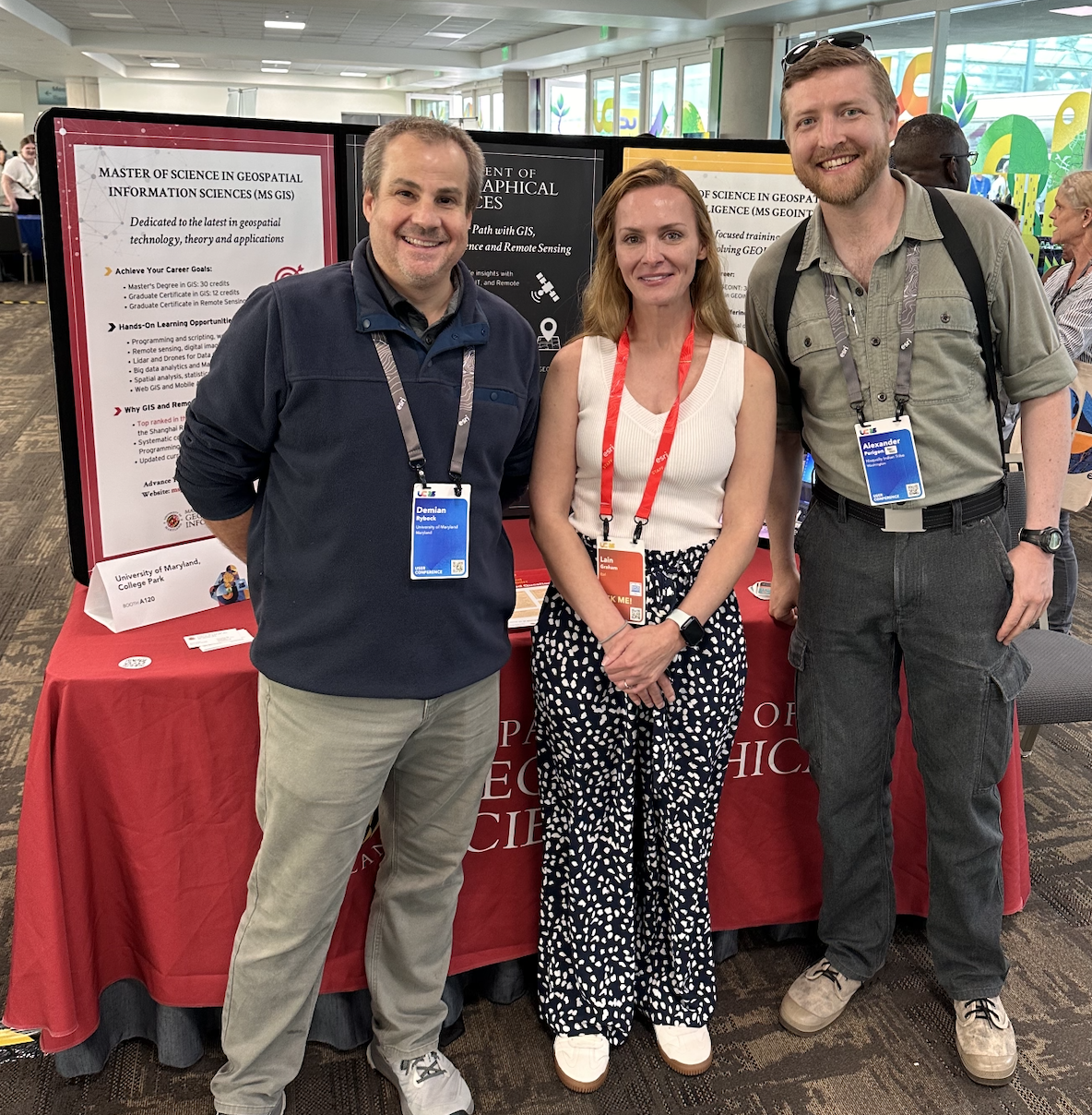 Demian Rybock (Left), Lain Graham (Center), and Alexander Perigon (Right) at the MS GIS and GEOINT table during the Academic Fair at the Esri User Conference