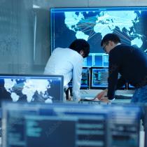 two men collaborating in a control room