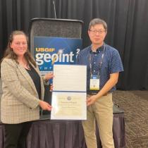 Photo of Dr. Han receiving USGIF accreditation