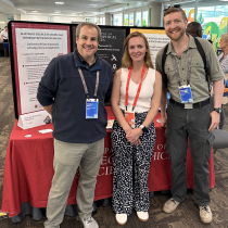 Demian Rybock (Left), Lain Graham (Center), and Alexander Perigon (Right) at the MS GIS and GEOINT table during the Academic Fair at the Esri User Conference