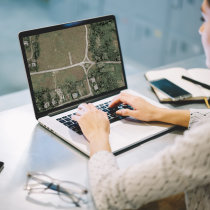 woman at computer with map