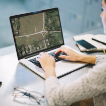 Woman on computer with coordinates 