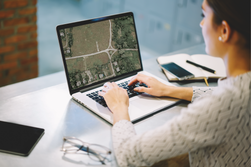 woman at laptop computer looking at a  map image