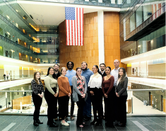 MS GEOINT and GIS students and lecturer Jonathon Hathaway pose for a group photo in the NGA facility